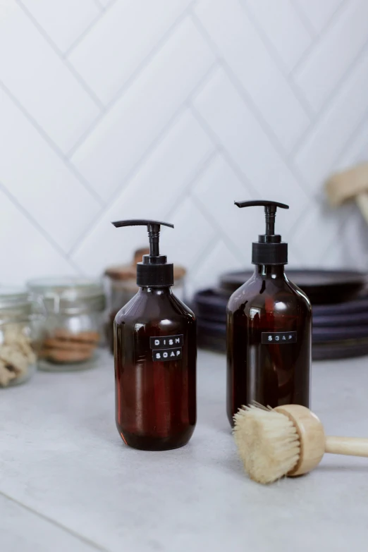 a couple of brown bottles sitting on top of a counter, soap, 2 1 0 mm, dark brown, thumbnail