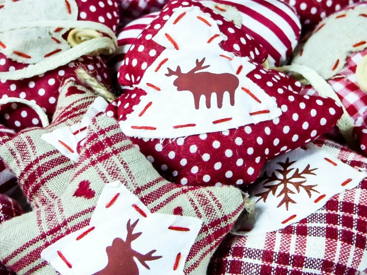 a pile of red and white christmas ornaments, pexels, folk art, made of fabric, cushions, maroon, rustic