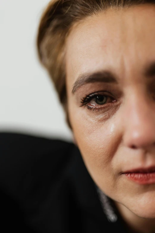 a close up of a person with a cell phone, sad eyebrows, woman in business suit, shot on canon eos r5, digital image