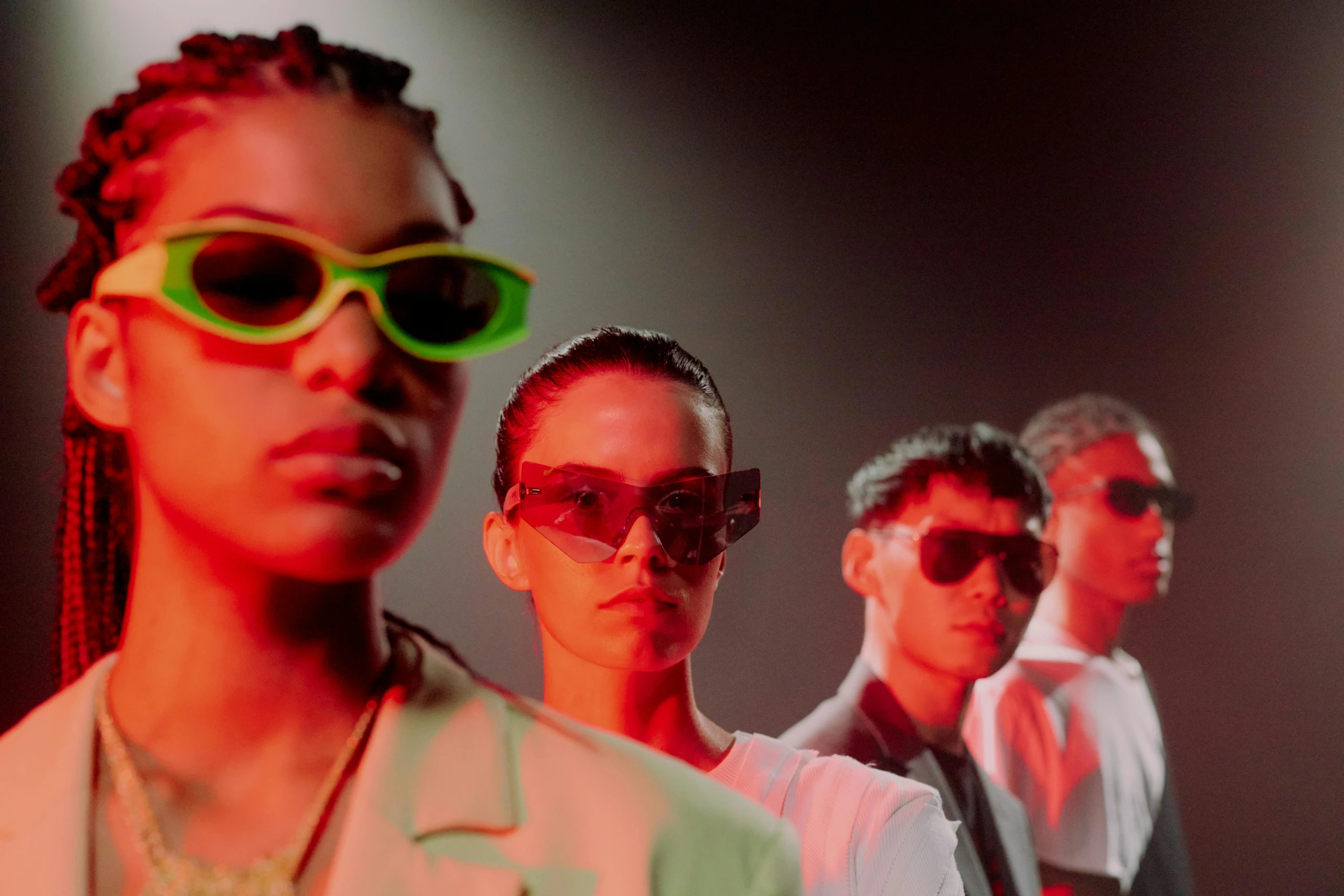 a group of people standing next to each other, trending on pexels, bauhaus, neon sunglasses!, non binary model, studio lit, gucci catwalk