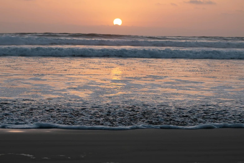 the sun is setting over the ocean on the beach, by Colijn de Coter, pexels contest winner, slight overcast, hd footage, round-cropped, australian beach