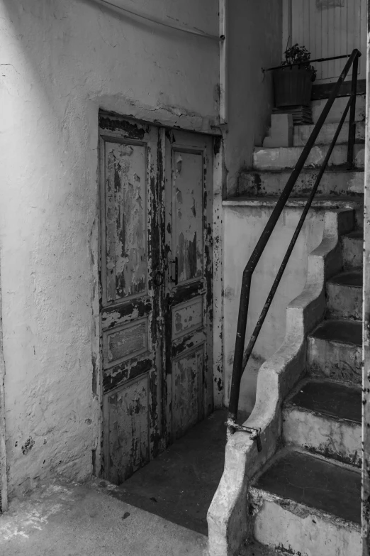 a black and white photo of a set of stairs, a black and white photo, inspired by André Kertész, flickr, rust and plaster materials, an escape room in a small, doors, colours