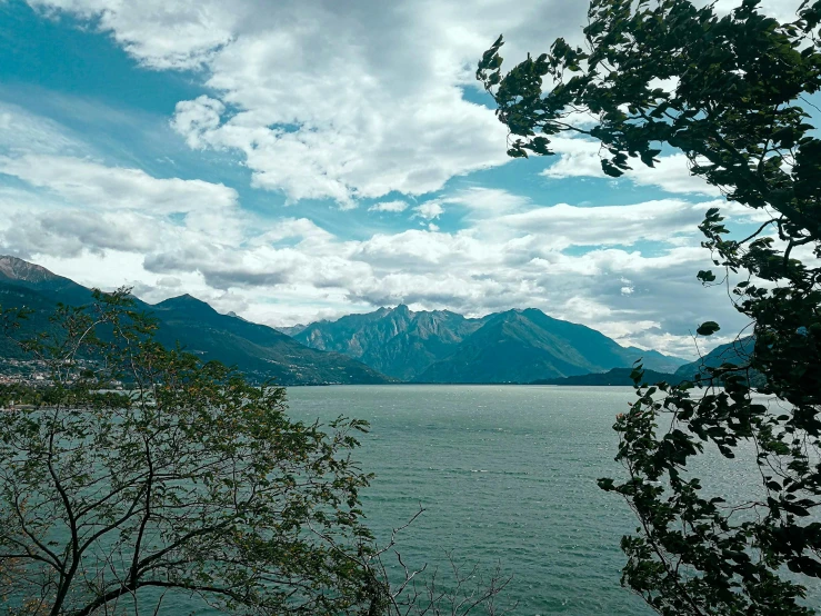 a large body of water with mountains in the background, unsplash contest winner, visual art, 2000s photo, shore of the lake, boka, british columbia