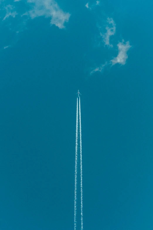 a large jetliner flying through a blue sky, by Andries Stock, pexels contest winner, minimalism, top down perspecrive, rocket, 1683, high picture quality