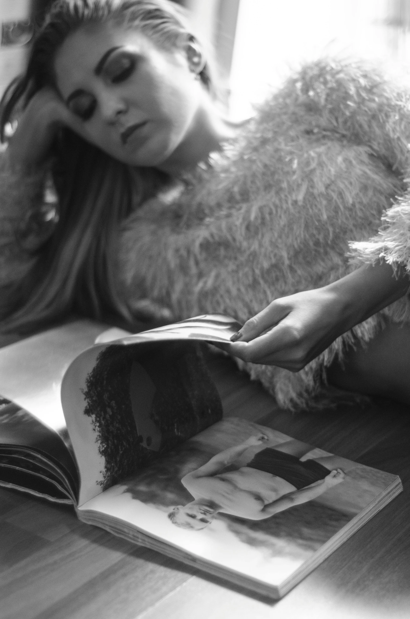 a black and white photo of a woman reading a book, a black and white photo, by Felix-Kelly, torn agazine, devon cady-lee, laying down, hair down