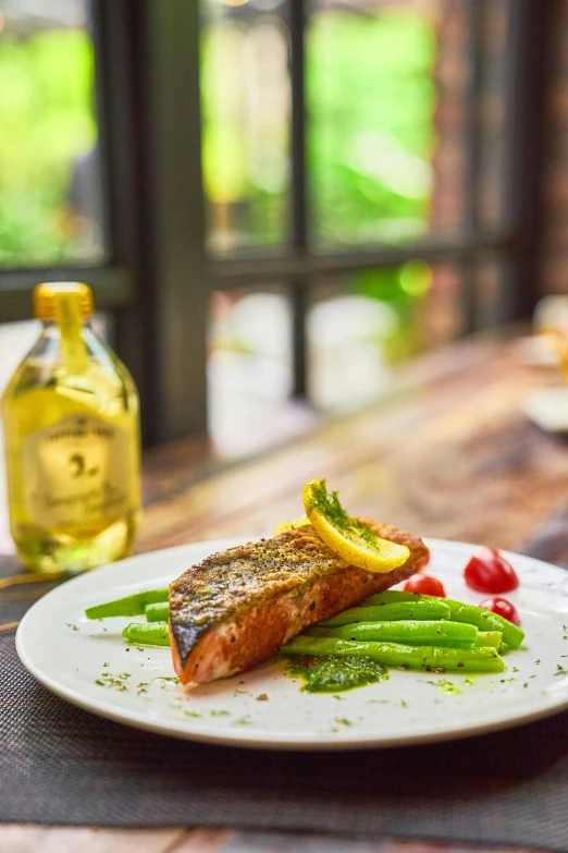 a close up of a plate of food on a table, fish in the background, lush surroundings, profile image, daily specials