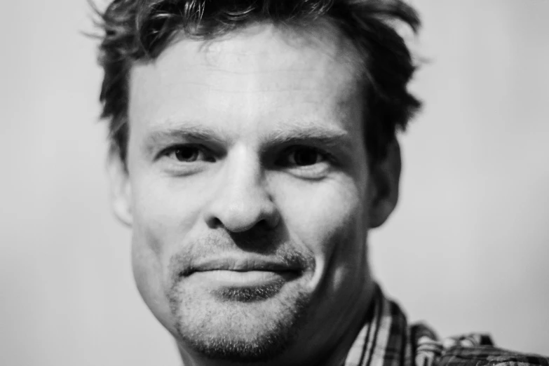 a black and white photo of a man, by Matthijs Naiveu, dexter morgan, smirking at the camera, in 2 0 1 5, ansel ]