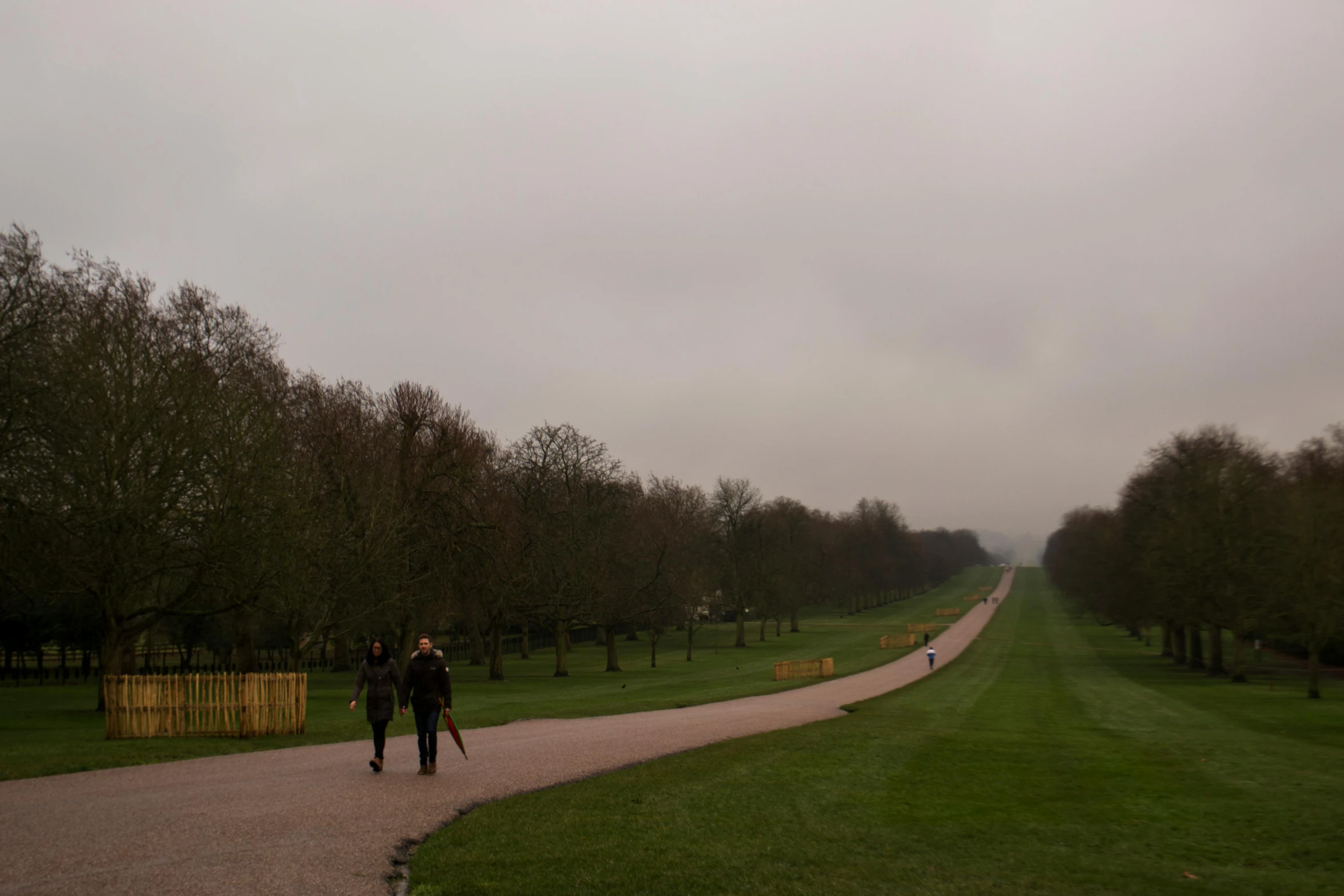 two people walking down a path in a park, a picture, overcast skies, royal palace, distant photo, image