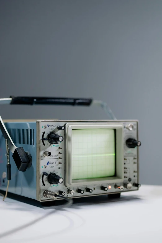 a radio sitting on top of a white table, oscilloscope, 1960s-era, adafruit, on display in a museum