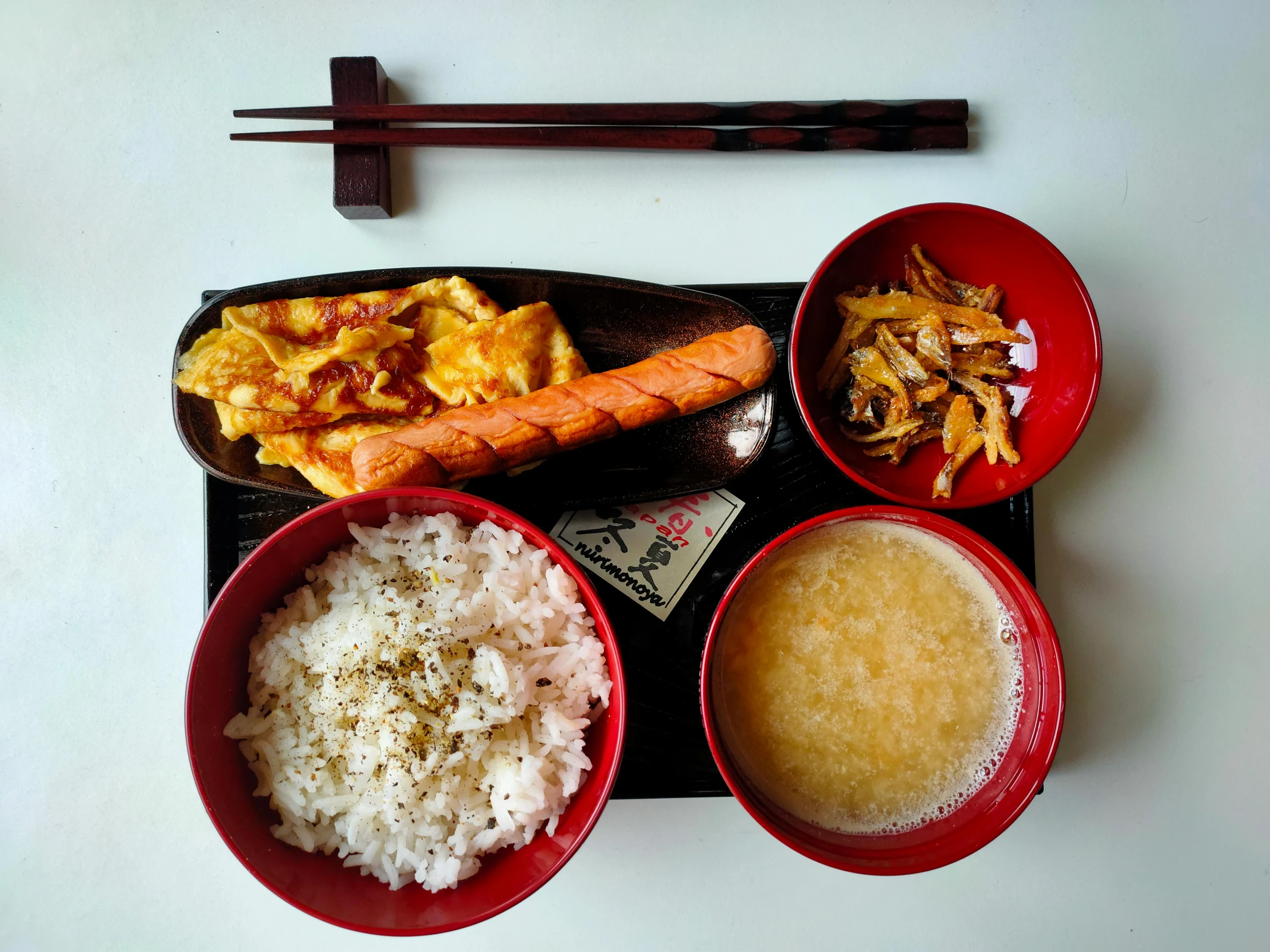 a table topped with bowls of food and chopsticks, a picture, unsplash, sōsaku hanga, yellow and red color scheme, 🦩🪐🐞👩🏻🦳, square, breakfast