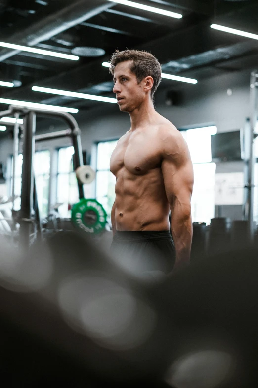 a man standing in a gym holding a barbell, by Adam Rex, pexels contest winner, shirtless :: high detail, lachlan bailey, 6 pack ab, gif