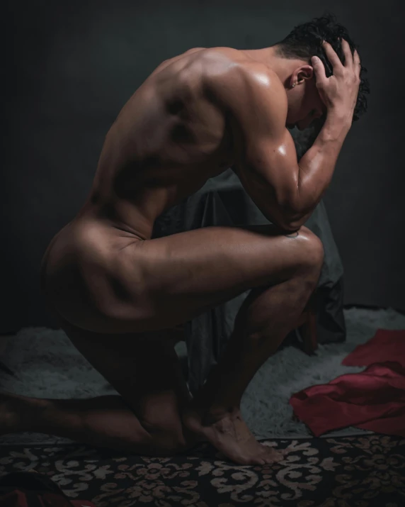 a naked man sitting on a bed with his head in his hands, a statue, by Cosmo Alexander, pexels contest winner, fleshy musculature, lgbt, kneeling!!, gif