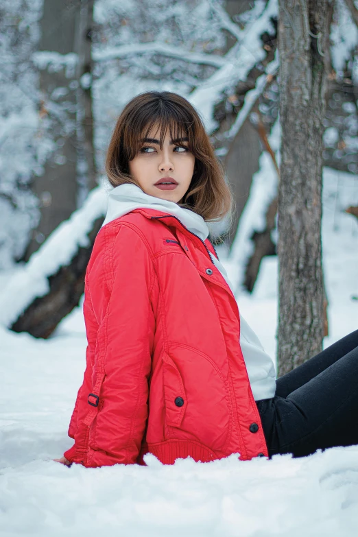 a woman sitting in the snow next to a tree, cool red jacket, alena aenami and lilia alvarado, wearing a flying jacket, promo image