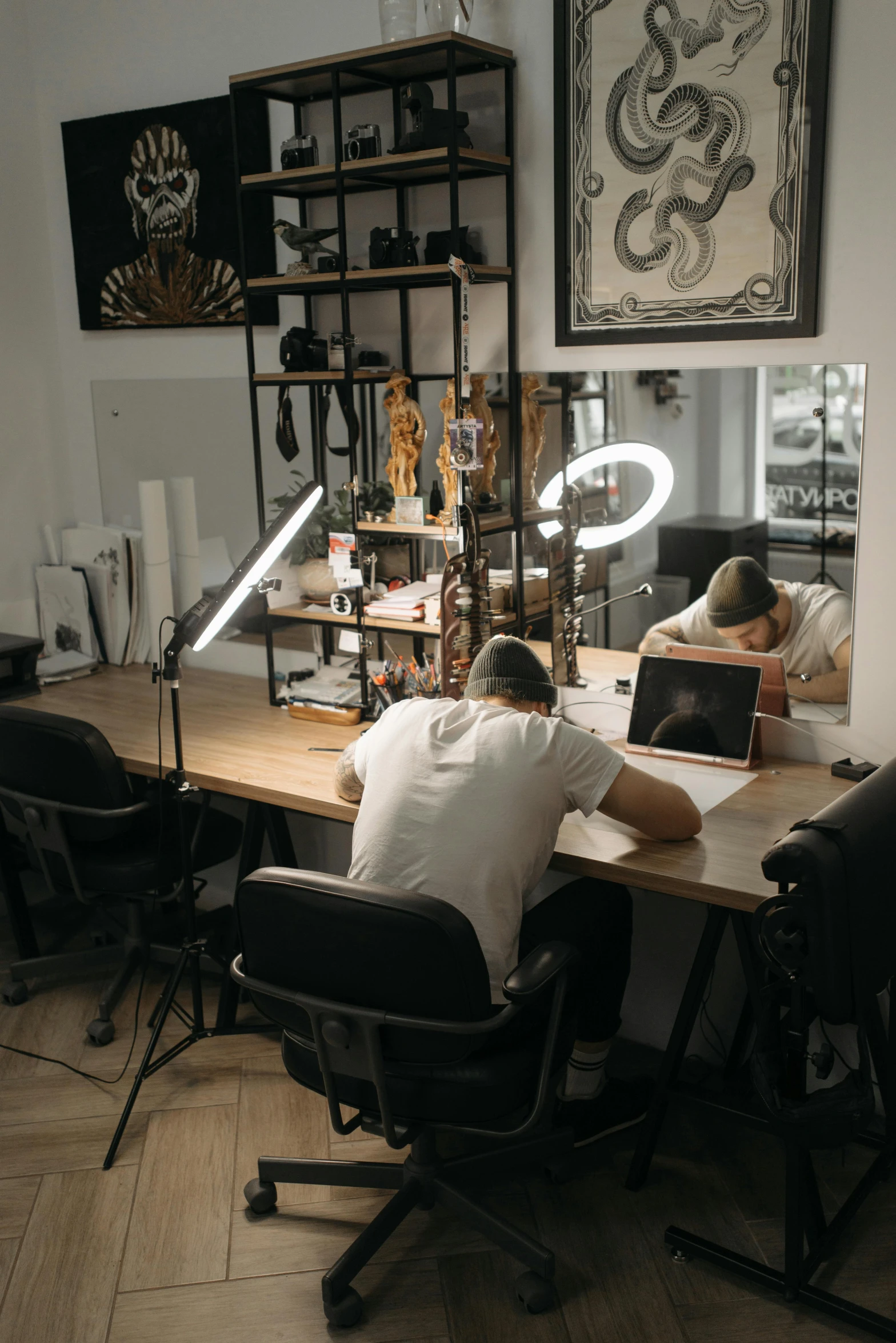 a couple of people that are sitting at a table, a tattoo, art workstation, ioyful vibe and lighting, sitting at his desk, facing away from the camera