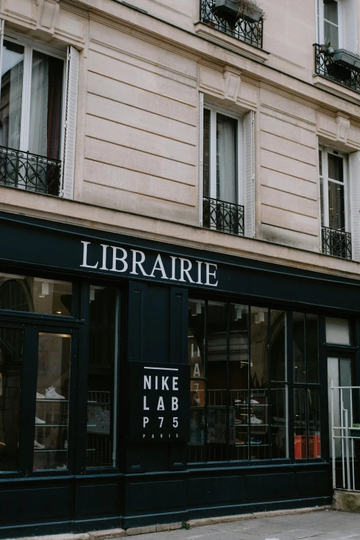 a woman walking down the street in front of a library, unsplash contest winner, paris school, nike logo, shop front, prairie, mike