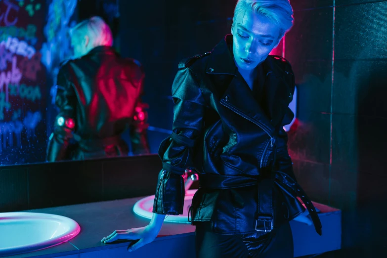 a woman standing in front of a mirror in a bathroom, cyberpunk art, inspired by Elsa Bleda, leather jackets, neon operator margot robbie, girl with short white hair, sydney sweeney