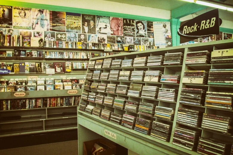 a store filled with lots of cds and cds, an album cover, pexels, william eggleston, 1980s photograph, in the style wes anderson, vintage style