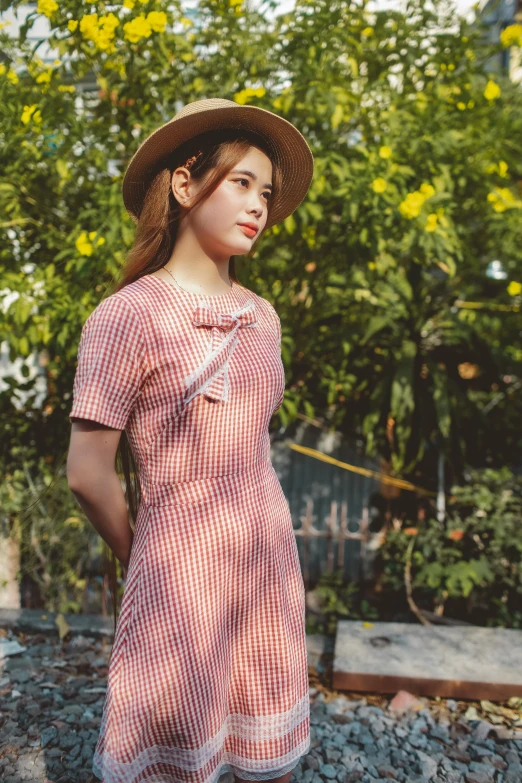 a woman in a dress and hat standing on a train track, a portrait, by Sengai, unsplash, cute checkerboard sundress, model エリサヘス s from acquamodels, pink and red color style, square