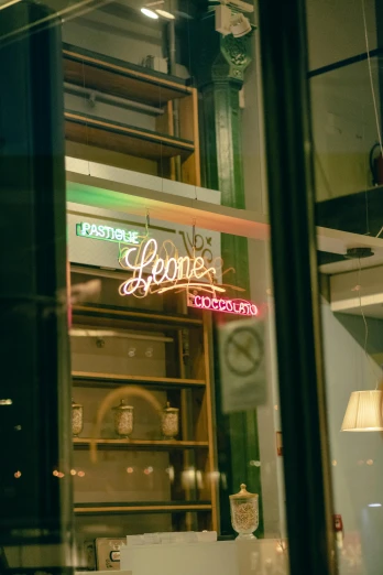 there is a neon sign in the window of a restaurant, a picture, by Jan Tengnagel, trending on pexels, bakery, lena oxton, ill of none, exiting store