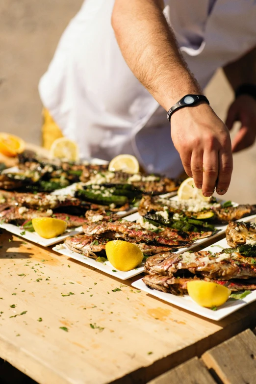 a close up of plates of food on a table, crabs, sleek hands, grills, performance