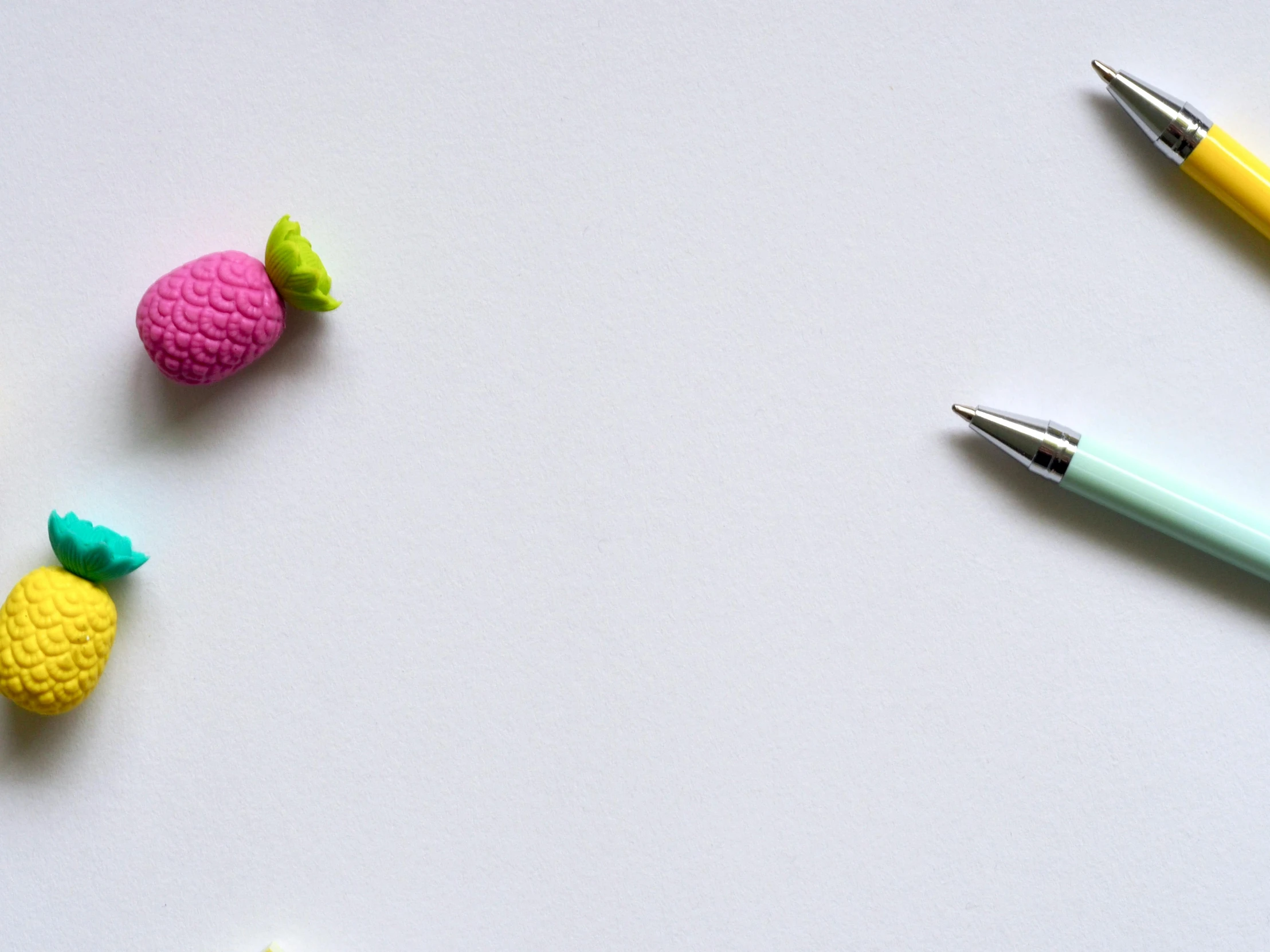 a couple of pens sitting on top of a white table, candy, background image, pink white turquoise, polymer clay