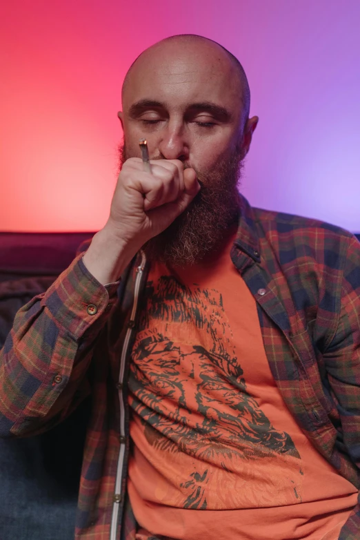 a man sitting on a couch smoking a cigarette, pexels, hyperrealism, wearing a red lumberjack shirt, mac miller, death grips, red beard