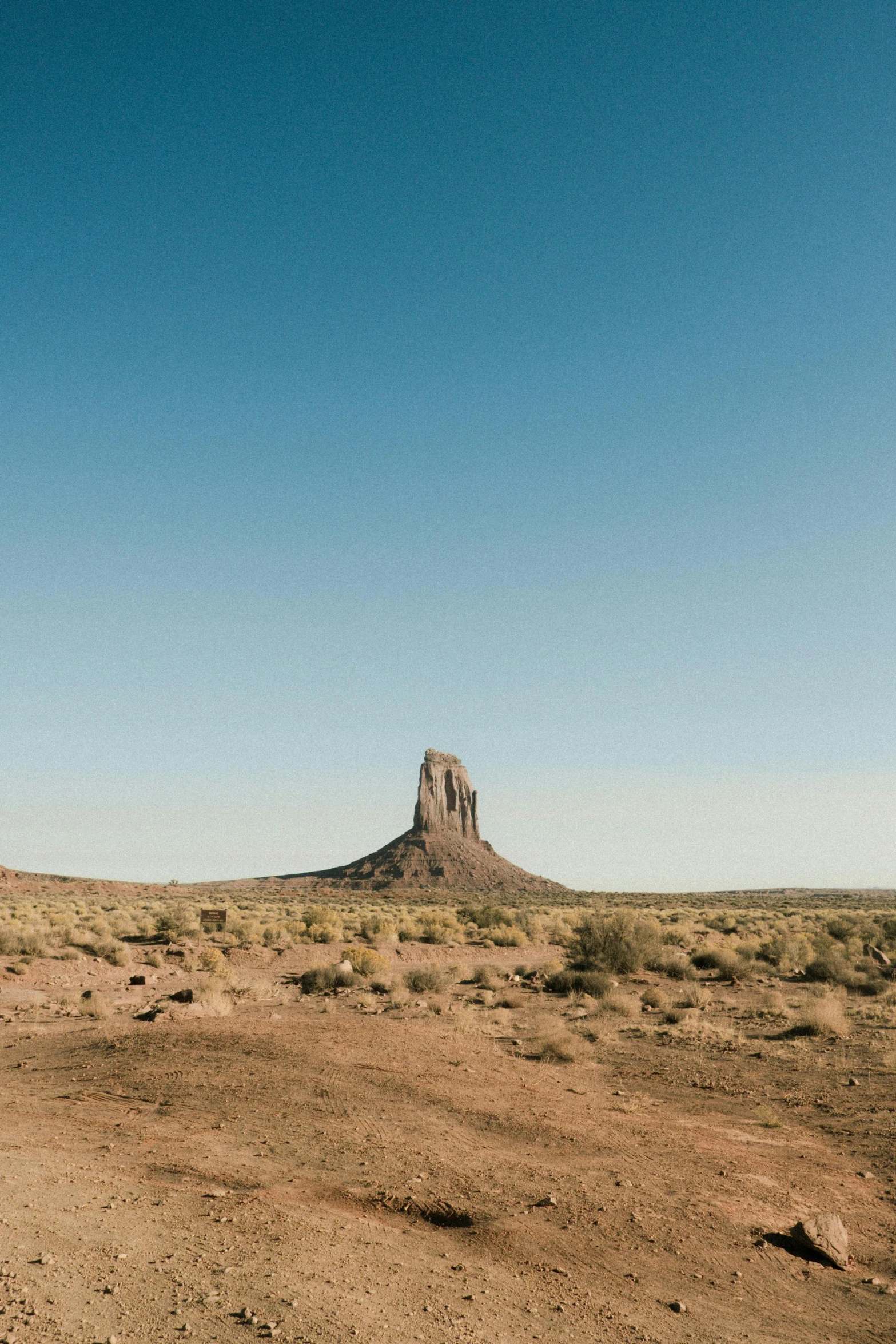 a dirt road in the middle of a desert, monumental structures, ((monolith)), unsplash photography, film photo