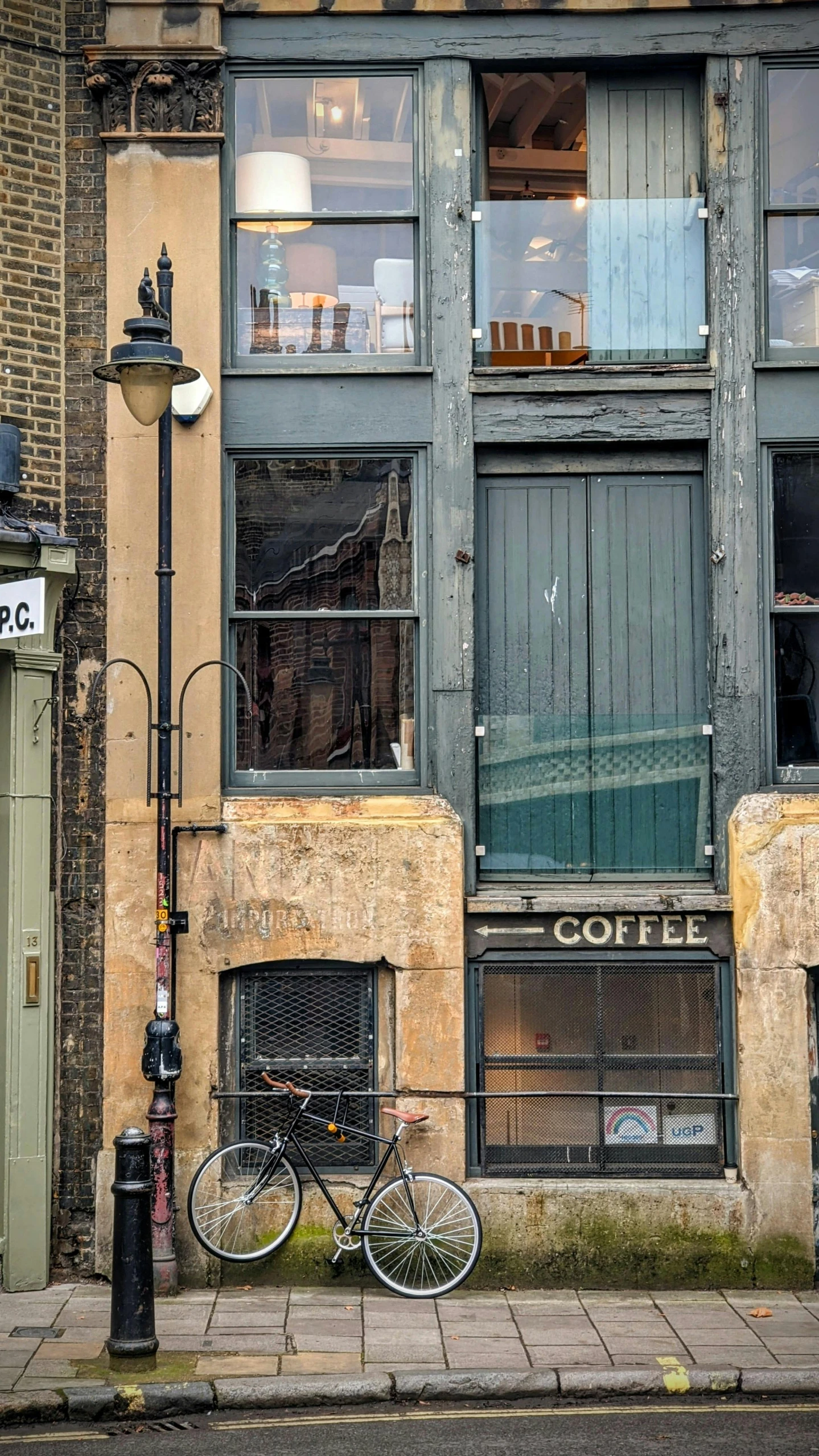 a bicycle is parked in front of a building, by Nick Fudge, pexels contest winner, spilt coffee, opposite the lift-shaft, golden windows, ffffound