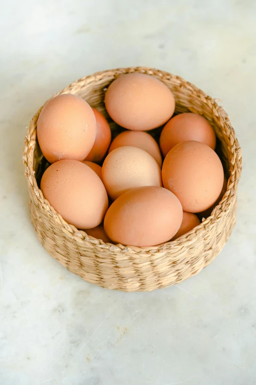 a basket filled with eggs sitting on top of a counter, natural soft rim light, organics, brown:-2, ballard