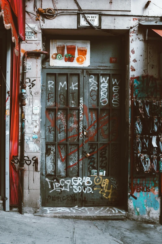 a red fire hydrant sitting on the side of a building, inspired by Elsa Bleda, pexels contest winner, graffiti, inside a bar, 3 doors, new york alleyway, doorway