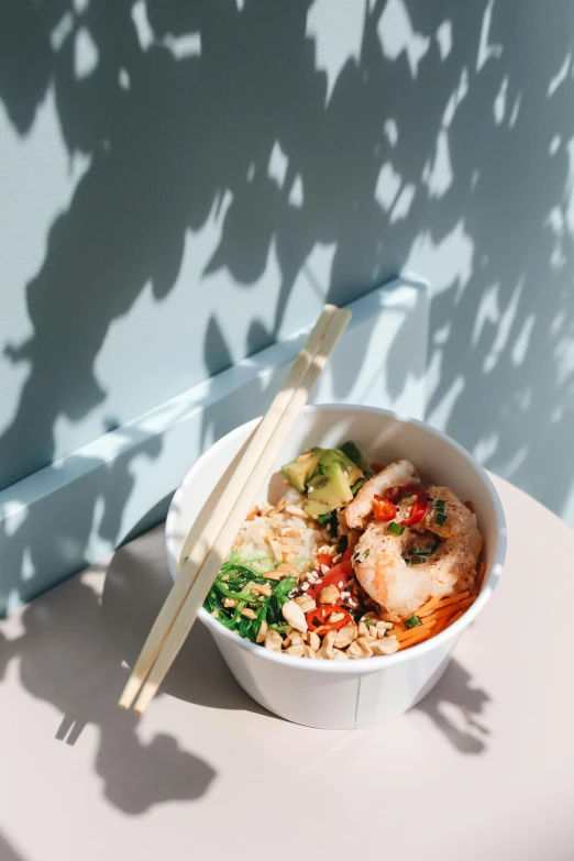 a close up of a bowl of food with chopsticks, in the sun, profile image, oceanside, product shot