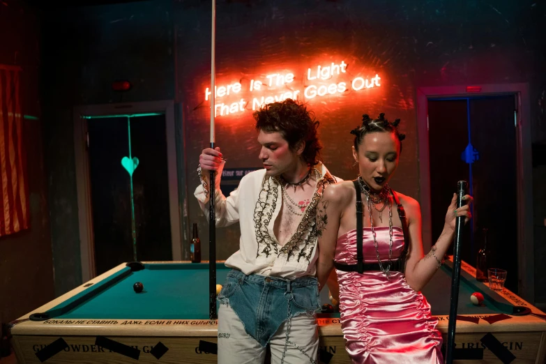 a man and a woman standing next to a pool table, 3 actors on stage, scene from a rave, alternative world, alana fletcher