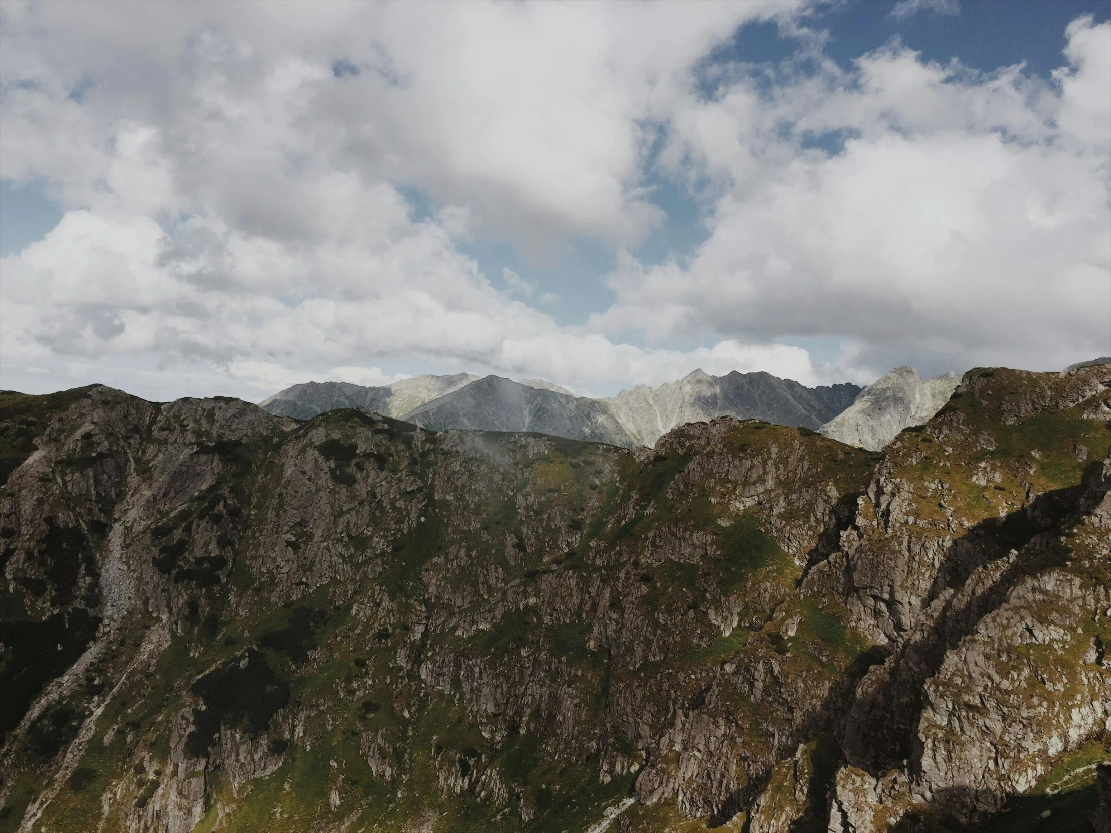 a group of people standing on top of a mountain, ultrawide image, photo of džesika devic, craggy mountains, high quality screenshot