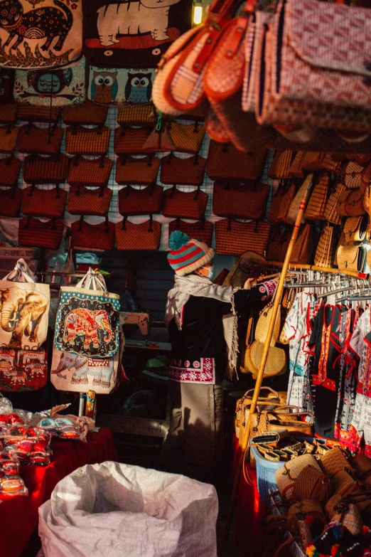 a store filled with lots of bags and purses, by Julia Pishtar, trending on unsplash, maximalism, nepal, winter season, thumbnail, market stalls