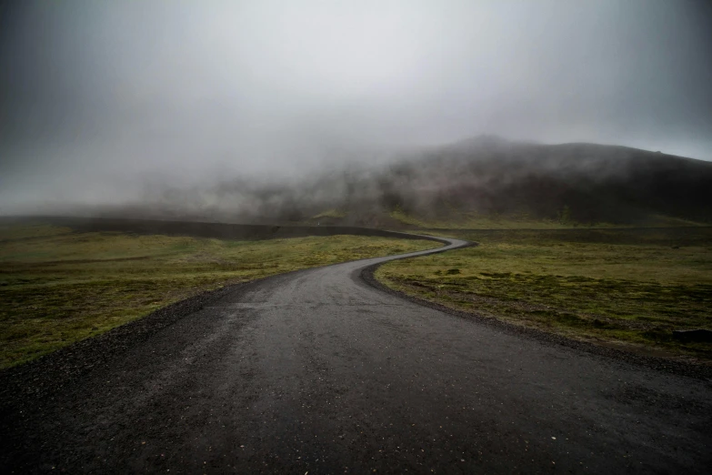 an empty road on a foggy day, by Hallsteinn Sigurðsson, pexels contest winner, realism, devils horns, background image, low clouds after rain, curving