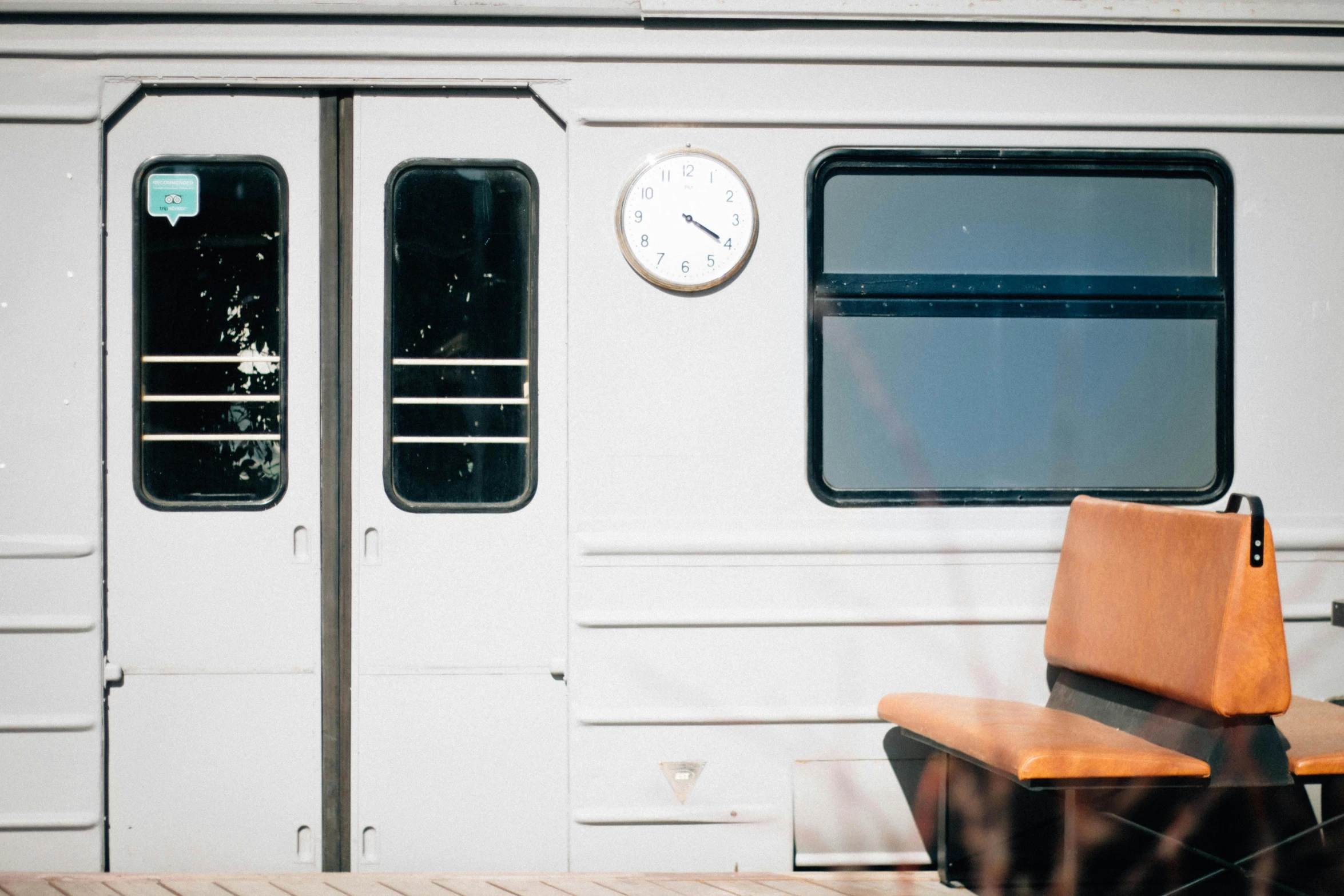 a clock that is on the side of a train, unsplash, postminimalism, chairlifts, 1980s photo, helsinki, 🚿🗝📝