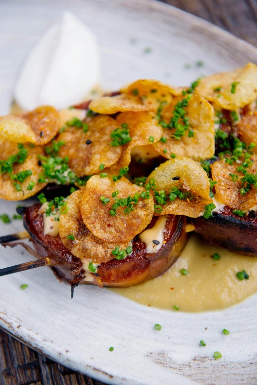 a close up of a plate of food on a table, inspired by Richmond Barthé, potato skin, tentacles wrapped around burgers, creamy, thumbnail