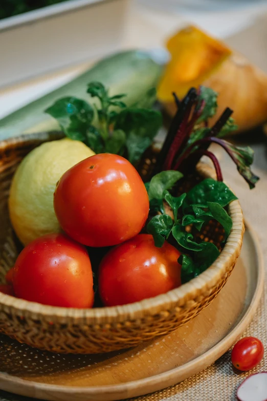 a bowl of fruit and vegetables on a table, tomatoes, comforting and familiar, indoor setting, vibrantly lush