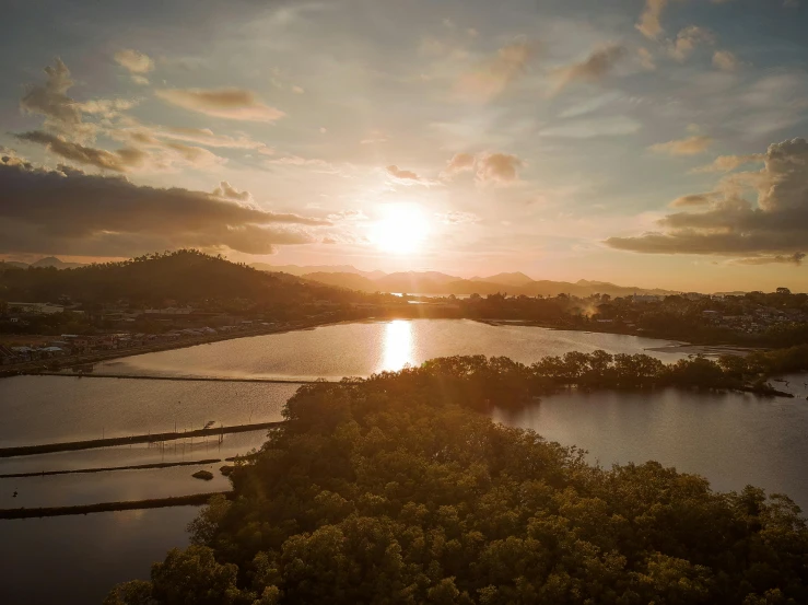 the sun is setting over a body of water, pexels contest winner, aerial view cinestill 800t 18mm, wide angle river, paradise in the background, waneella