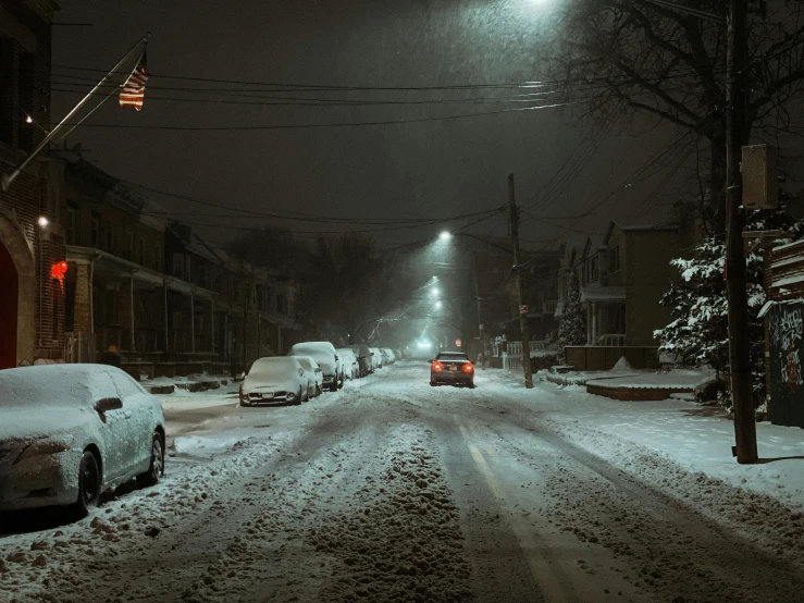 a city street covered in snow at night, a photo, inspired by Elsa Bleda, unsplash contest winner, photorealism, new jersey, ☁🌪🌙👩🏾, car shot, american suburb