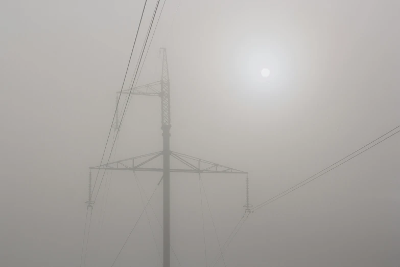 power lines on a foggy day with the sun in the background, a portrait, by Jan Rustem, moonlight grey, grey, giant sun, in the thick fog