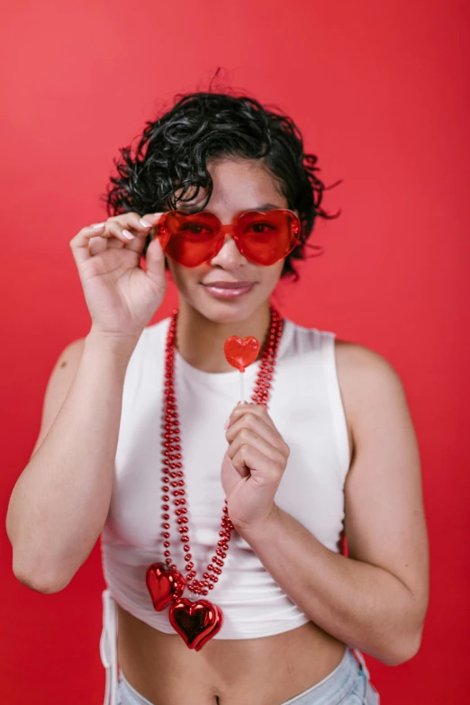 a woman holding a heart shaped lollipop lollipop lollipop lollipop lollipop lollipop lollipop lo, by Winona Nelson, renaissance, red sunglasses, tessa thompson inspired, studio portrait, an epic non - binary model