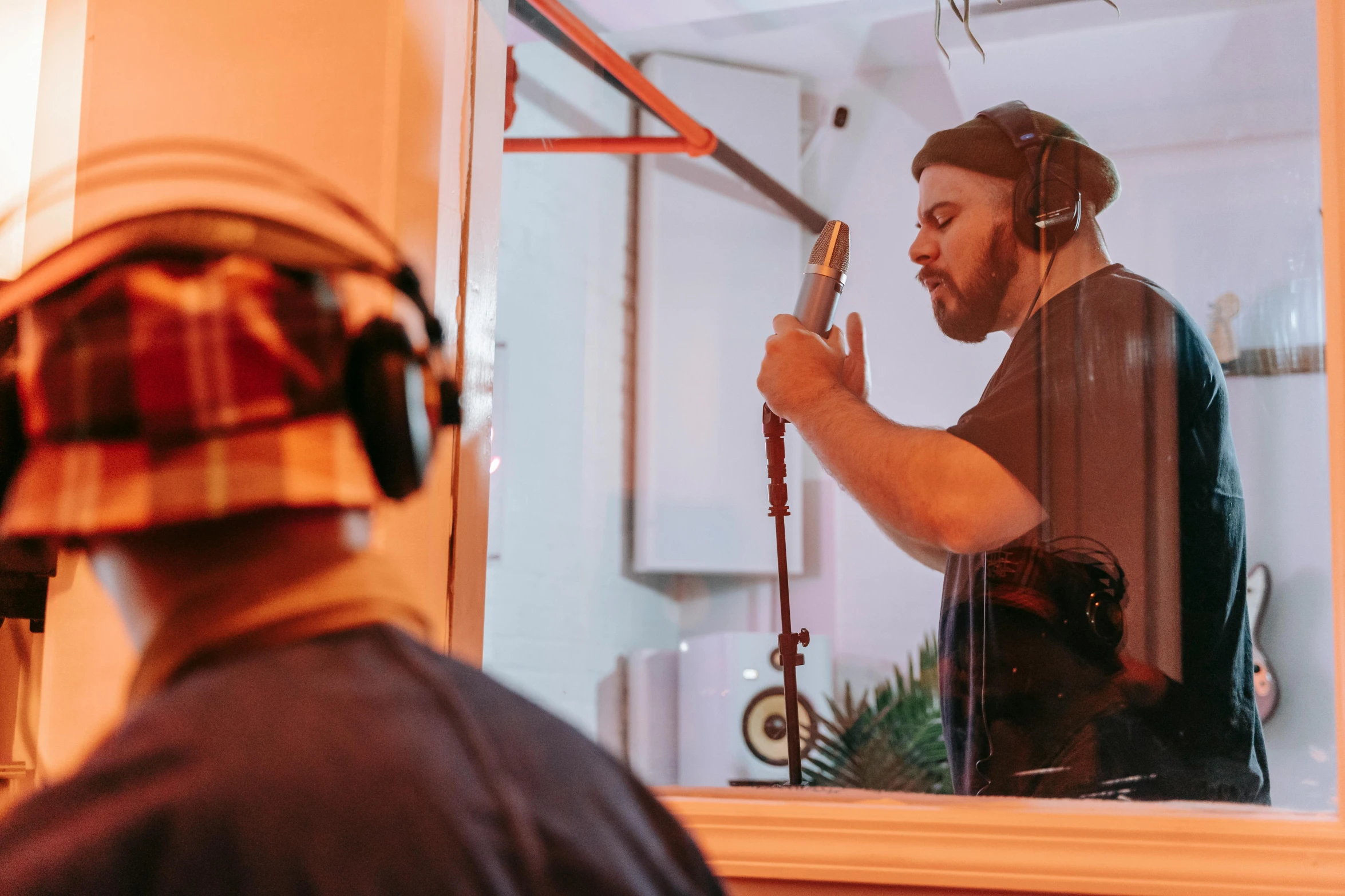a man that is standing in front of a mirror, with head phones, action bronson, in a studio, profile image