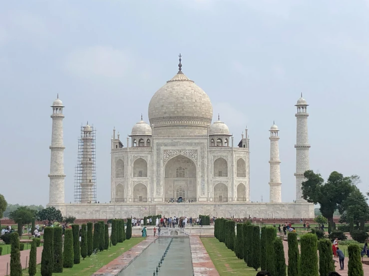 a group of people standing in front of a building, a marble sculpture, taj mahal, from the distance, during the day, 1km tall