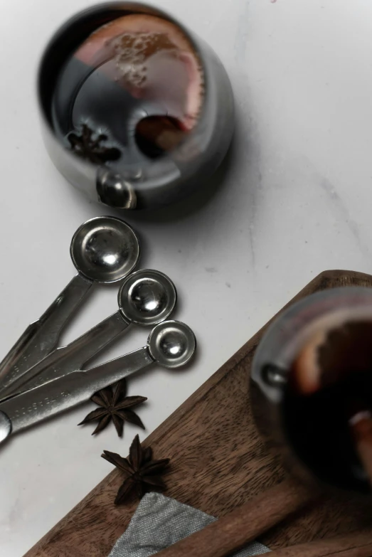 a pair of scissors sitting on top of a cutting board, beakers, in gunmetal grey, spices, thumbnail