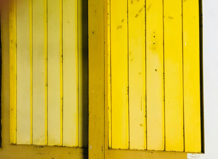 a red fire hydrant sitting in front of a yellow door, by Sven Erixson, postminimalism, wooden walls brass panels, colors: yellow, diptych, shack close up