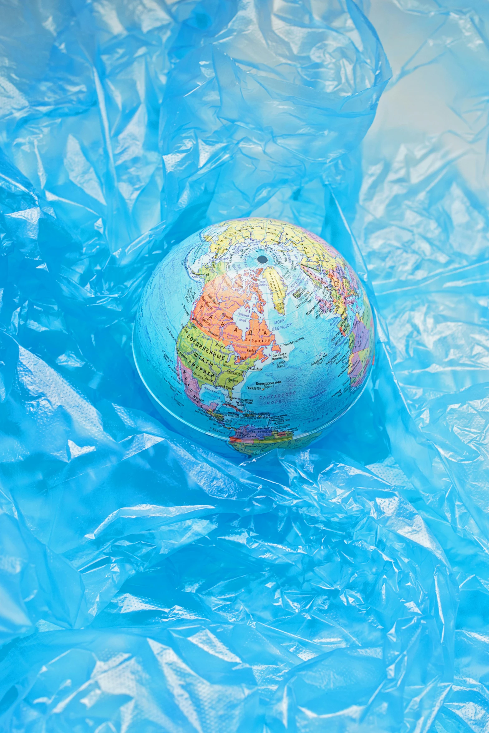 a blue plastic bag with a globe in it