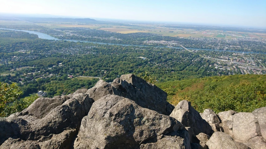 a view of a city from the top of a mountain, csók istván, large rocks, craigville, nature photo