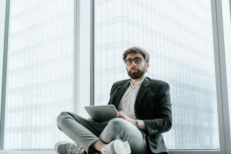a man sitting on the floor using a tablet computer, inspired by Nelson Alexander Ross, pexels contest winner, corporate boss, portrait of tall, lachlan bailey, khyzyl saleem