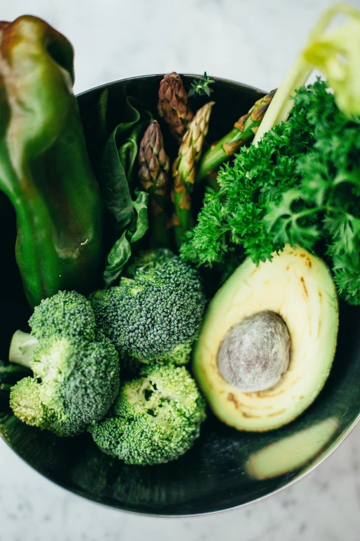 a bowl filled with broccoli and other vegetables, a still life, pexels, avocados, lush greens, green hood, in detail